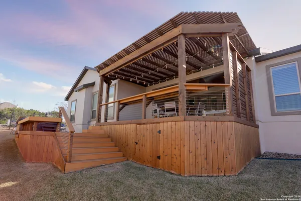 a view of a house with a wooden fence