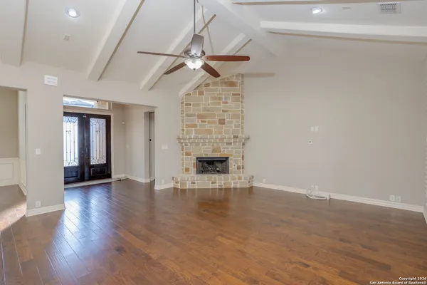a view of empty room with wooden floor