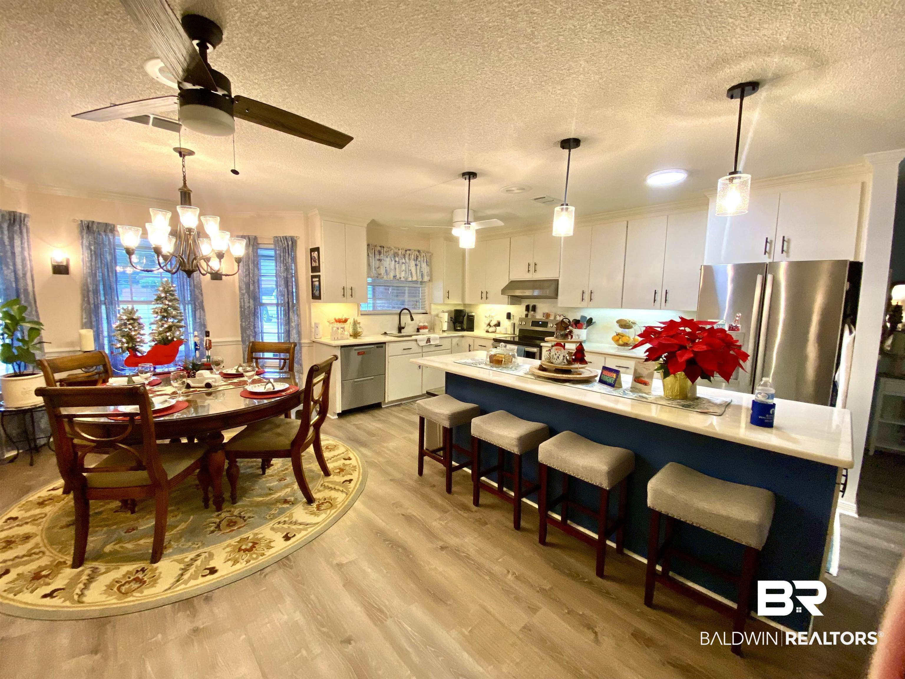 2872 Avenida Alberto Lillian, AL 36549 - Photo 12 of 31 Dining area with light hardwood / wood-style flooring, ceiling fan with notable chandelier, and a textured ceiling