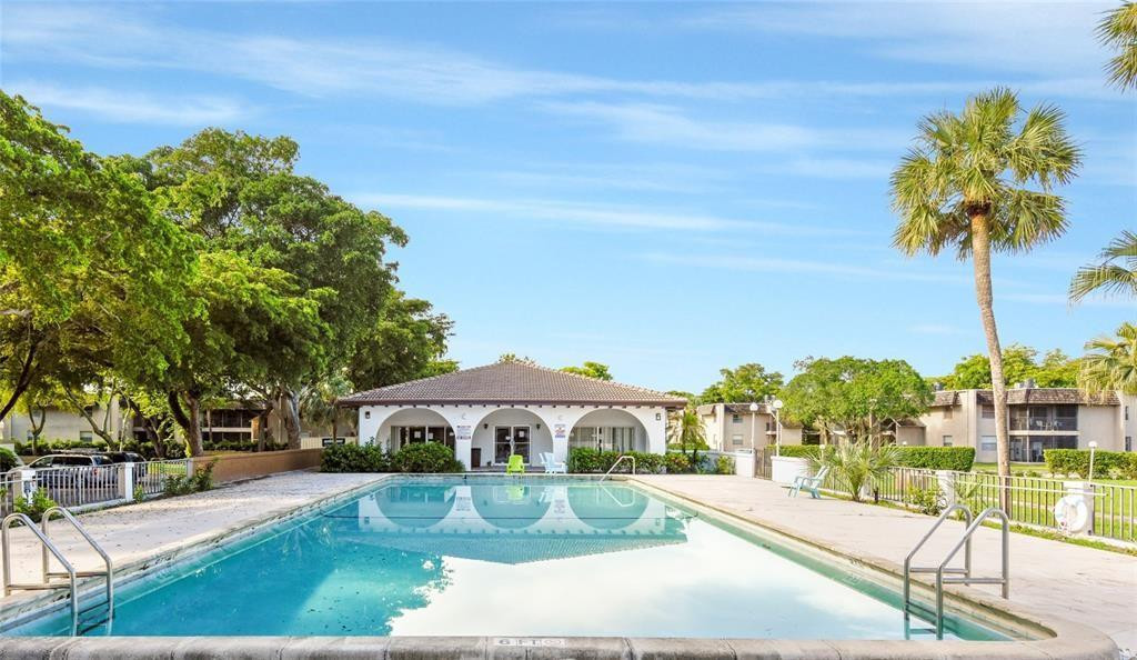2700 Riverside Drive, Unit 302B Coral Springs, FL 33065 - Photo 1 of 7 a view of a garden with a fountain