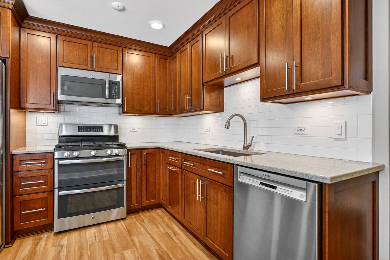 N049 Page Street Winfield, IL 60190 - Photo 5 of 31 a kitchen with stainless steel appliances granite countertop a stove microwave and sink