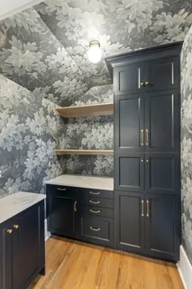 a bathroom with a granite countertop sink a vanity and a large mirror
