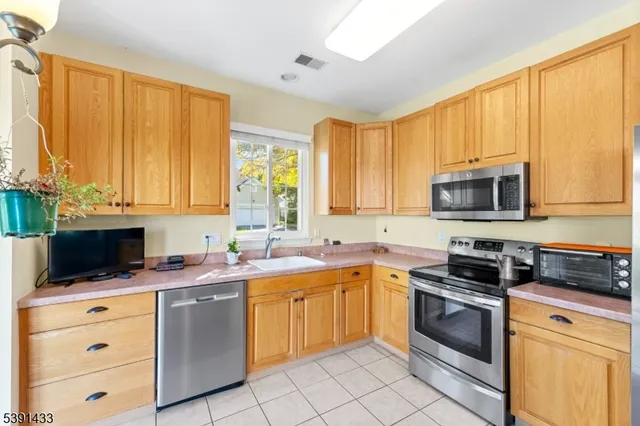 a kitchen with a stove a sink and a microwave