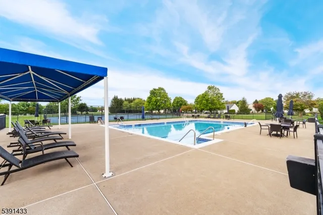 a view of a swimming pool with sitting area