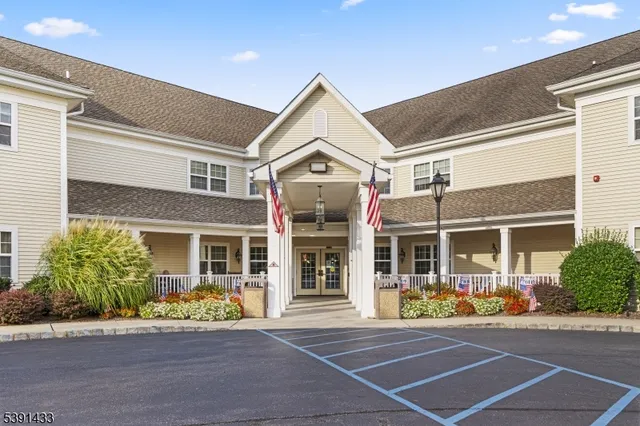 a living room with furniture fireplace and large windows
