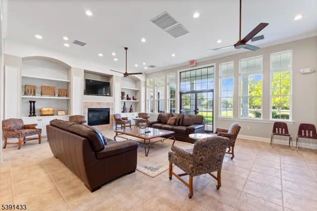 a living room with fireplace furniture and a chandelier