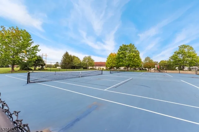 a aerial view of a house with a yard basket ball court and outdoor seating