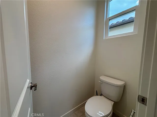 a white toilet sitting next to a shower