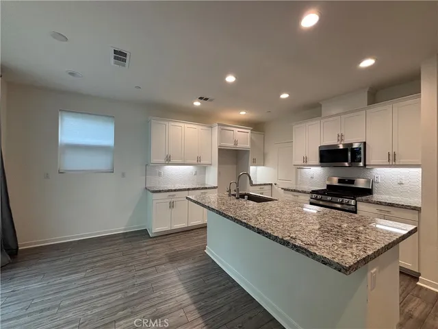 a kitchen with a stove a sink and a refrigerator