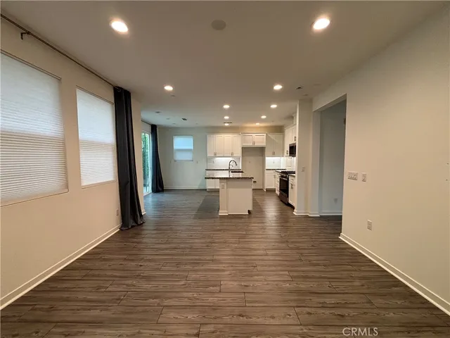 a view of kitchen with kitchen island and stainless steel appliances