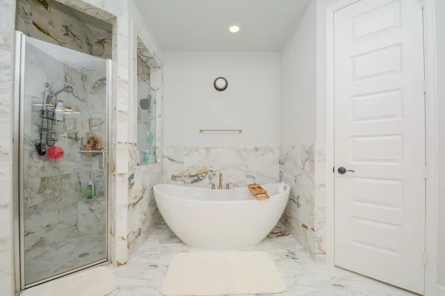 a bathroom with a bathtub and shower