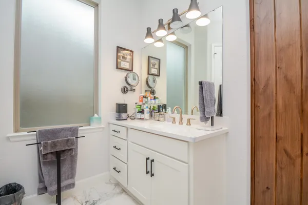 a bathroom with a sink vanity and a mirror