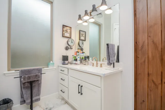 a bathroom with a sink vanity and a mirror