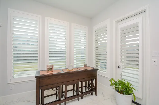 a view of a room that has a table and chair in it