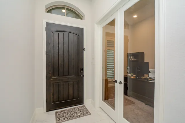 a bathroom with a glass door shower and a sink