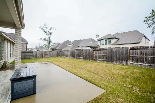 a swimming pool with outdoor seating and yard