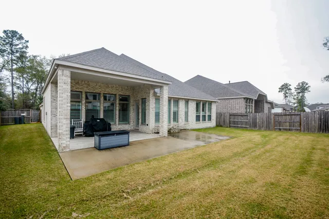 a view of a house with a yard and sitting area