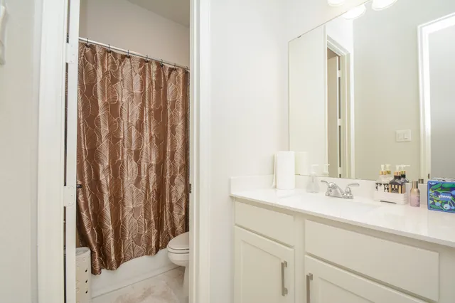 a bathroom with a double vanity sink and a mirror