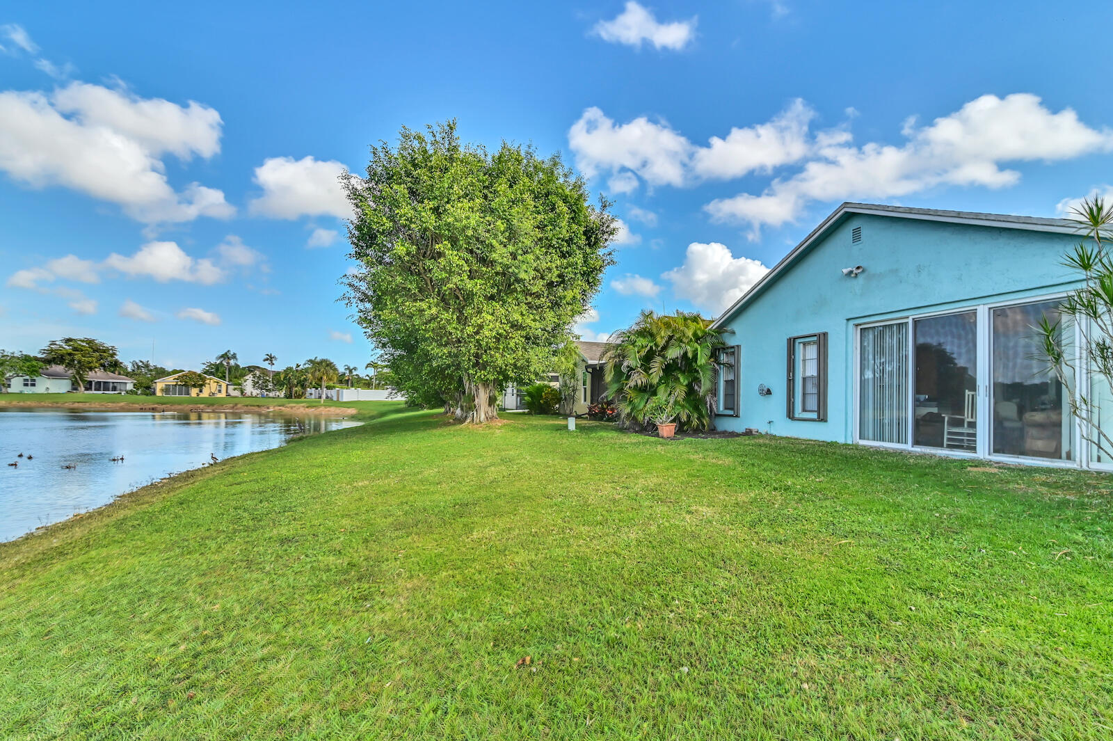 9075 Pine Springs Drive Boca Raton, FL 33428 - Photo 2 of 7 a view of a house with a yard