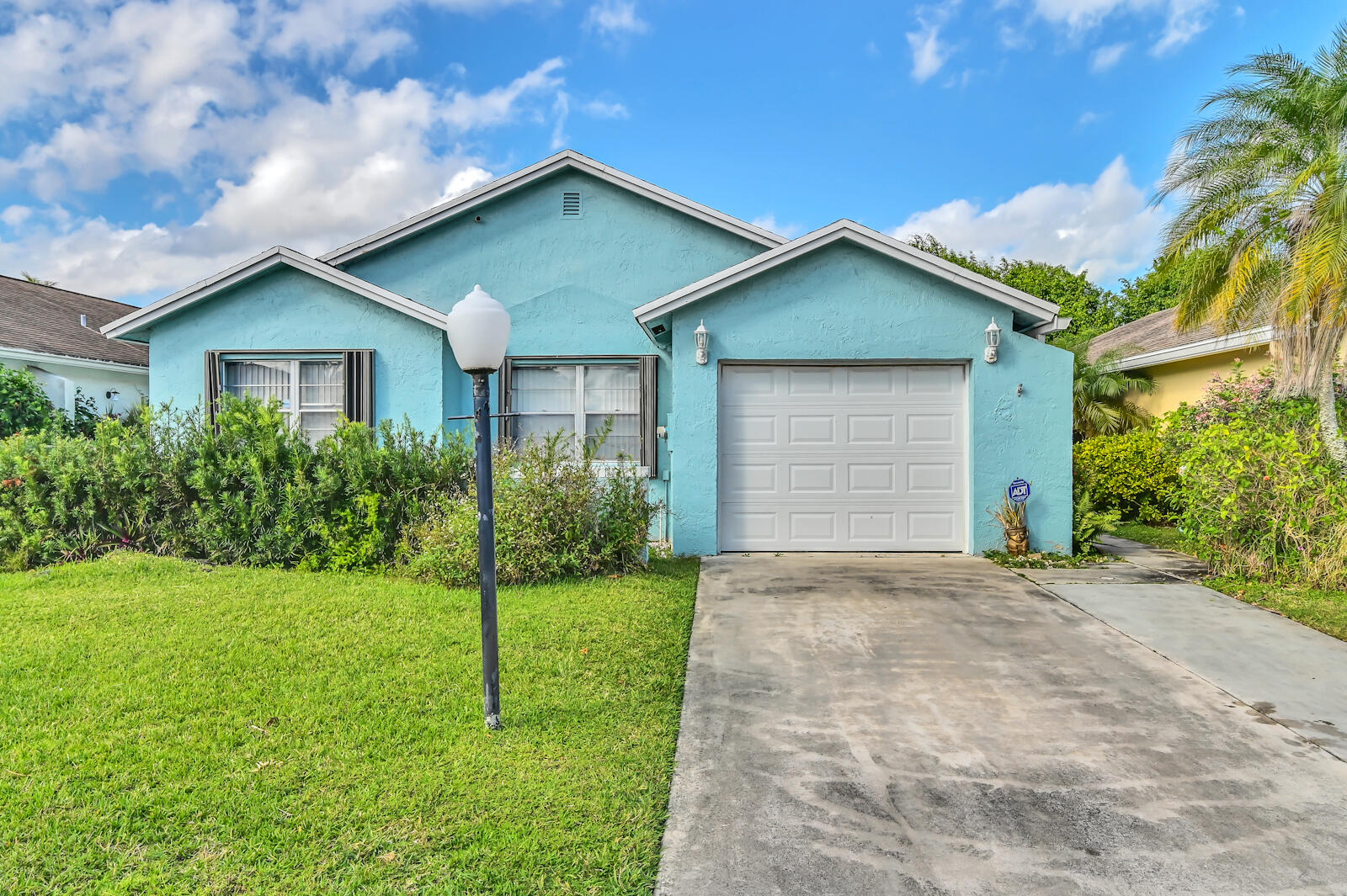 9075 Pine Springs Drive Boca Raton, FL 33428 - Photo 3 of 7 a front view of house with yard and green space