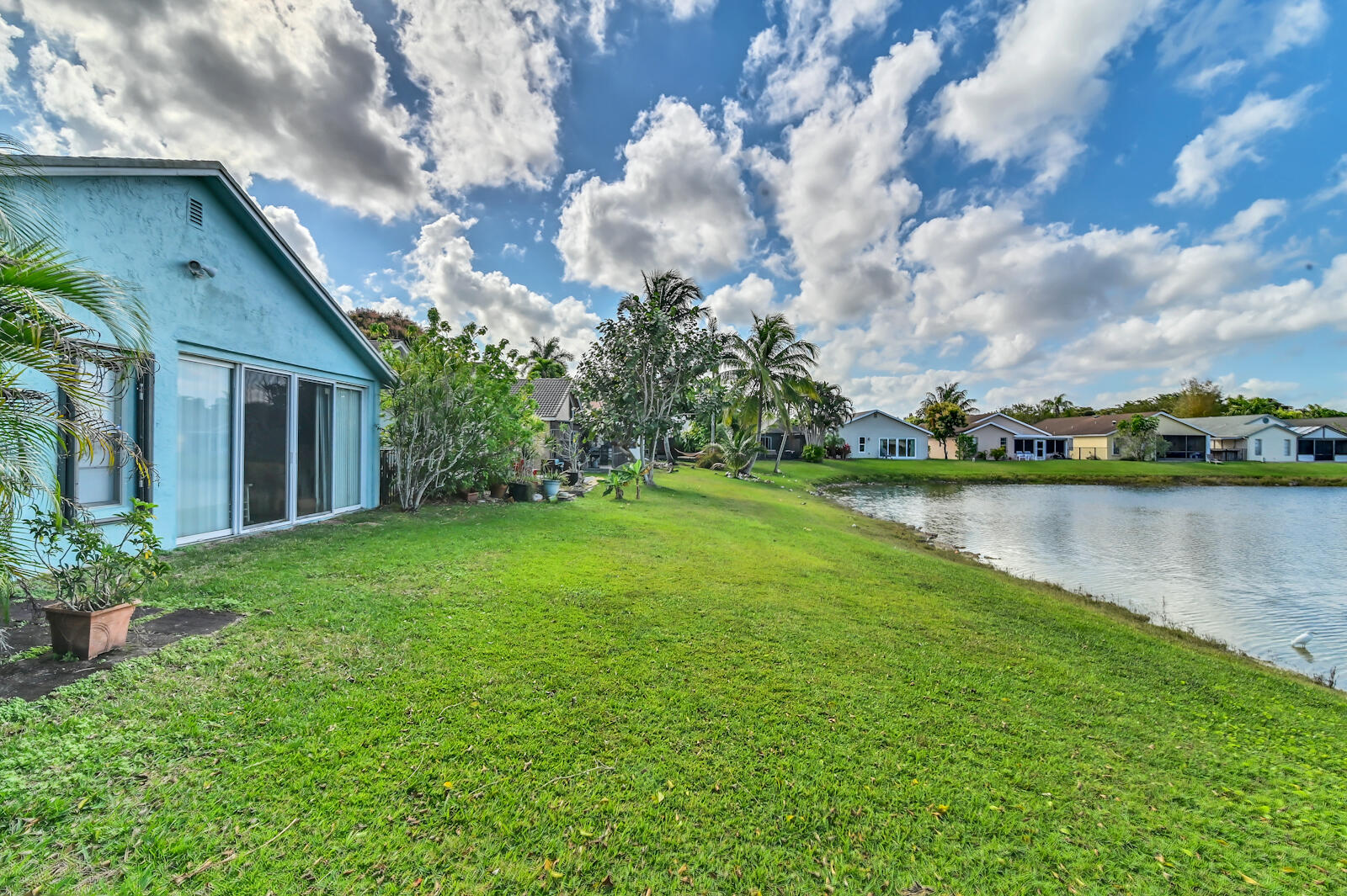 9075 Pine Springs Drive Boca Raton, FL 33428 - Photo 7 of 7 a backyard of a house with lots of green space