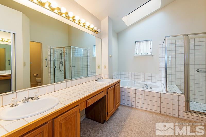 3307 Current Court Reno, NV 89509 - Photo 13 of 19 a bathroom with a sink double vanity granite tub shower and a mirror