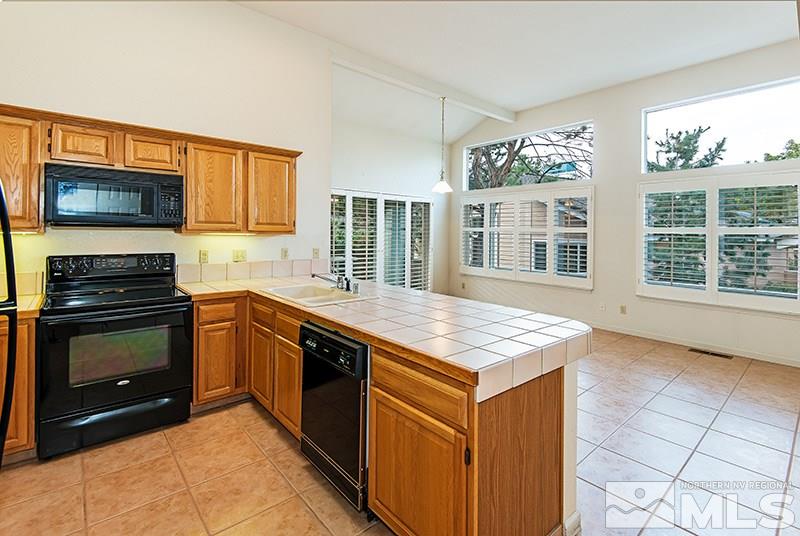 3307 Current Court Reno, NV 89509 - Photo 6 of 19 a kitchen with stainless steel appliances granite countertop a stove a sink and a microwave