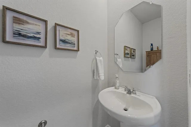 a bathroom with a sink and mirror