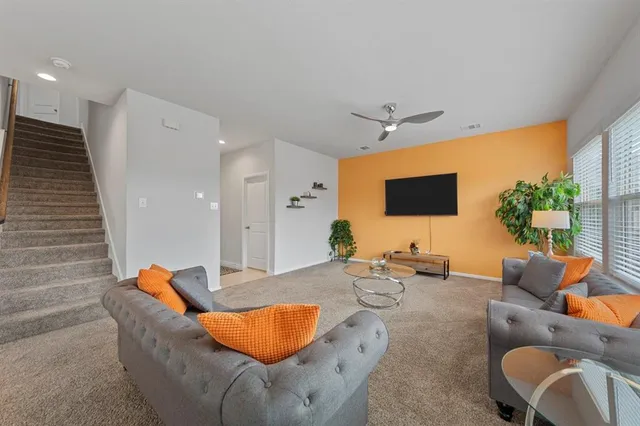 a outdoor living space with furniture and a flat screen tv