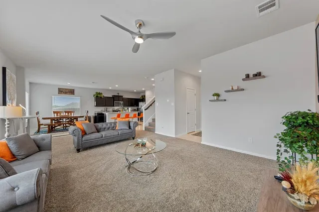a living room with furniture and a potted plant