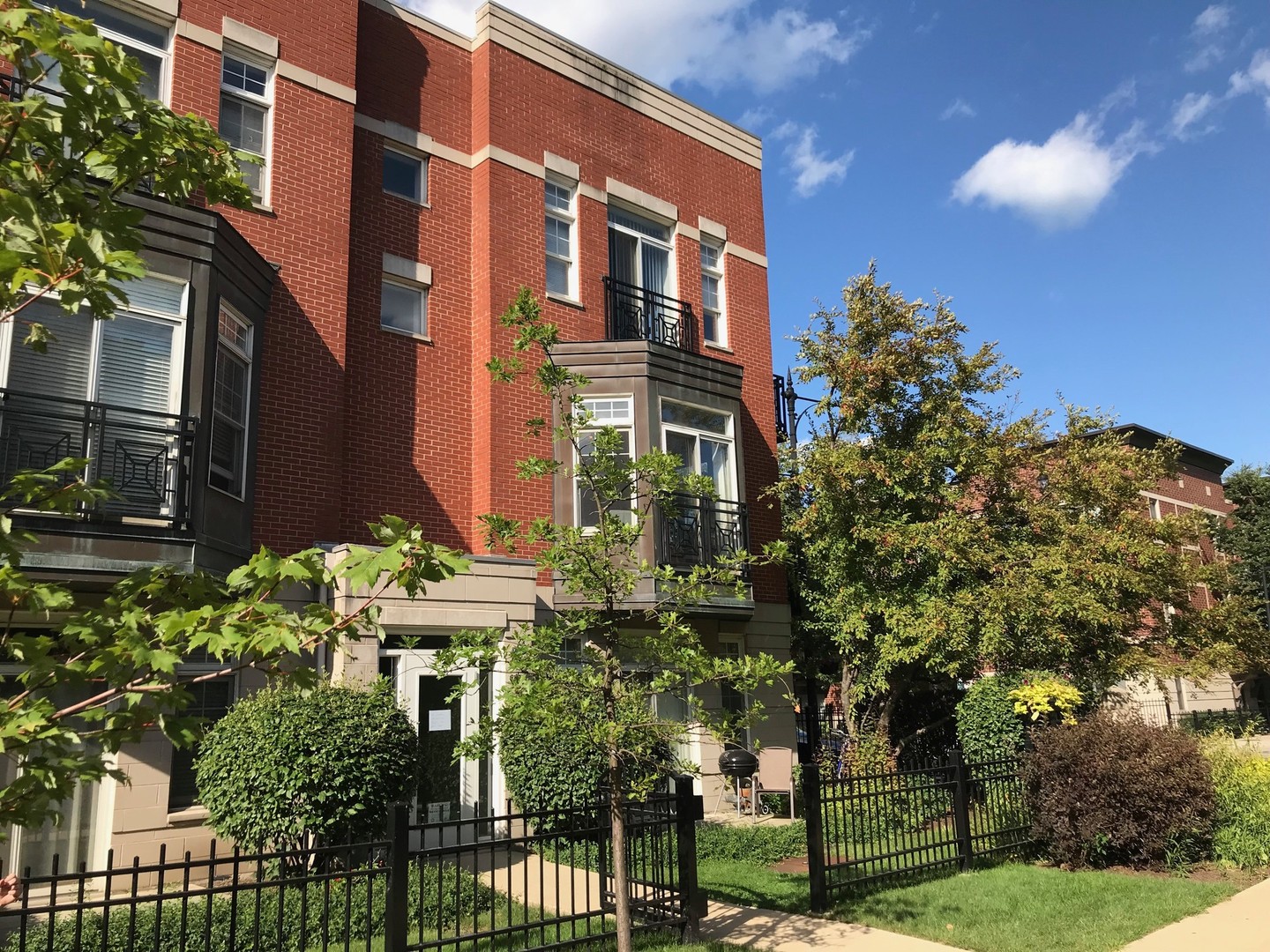 802 West University Lane, Unit 2B Chicago, IL 60608 - Photo 2 of 17 a view of a brick building next to a yard