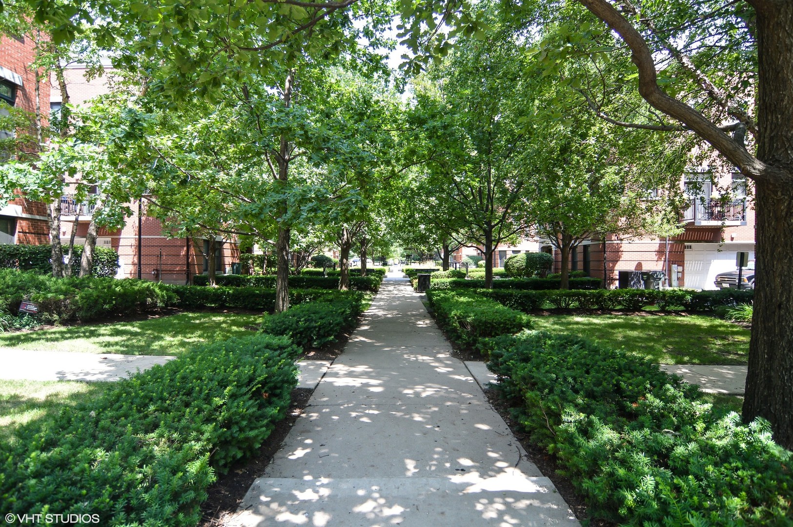 802 West University Lane, Unit 2B Chicago, IL 60608 - Photo 14 of 17 a view of pathway in front of house with green space
