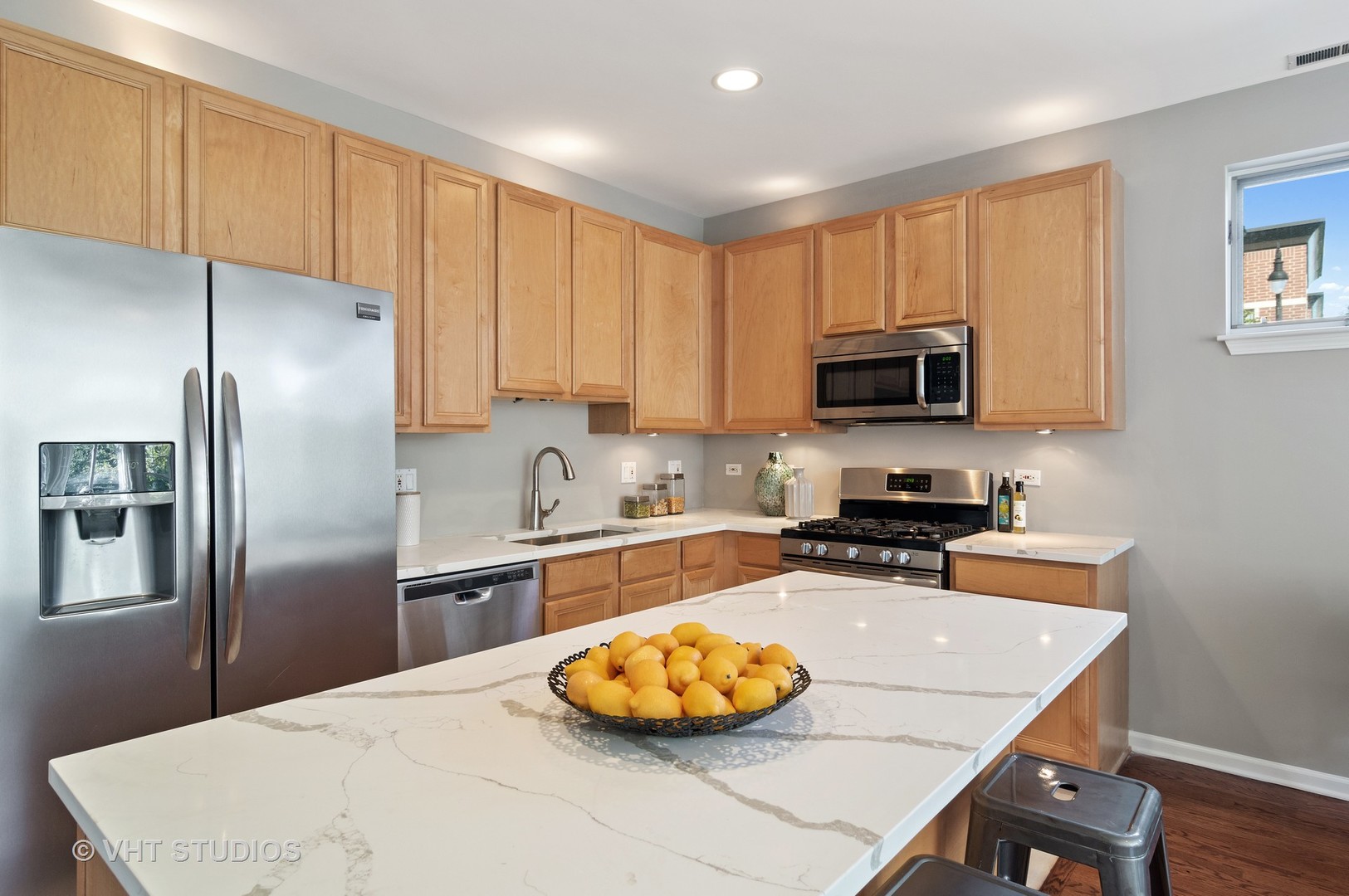 802 West University Lane, Unit 2B Chicago, IL 60608 - Photo 6 of 17 a kitchen with stainless steel appliances a stove a sink a refrigerator and a center island