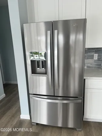a metallic refrigerator freezer sitting in a kitchen