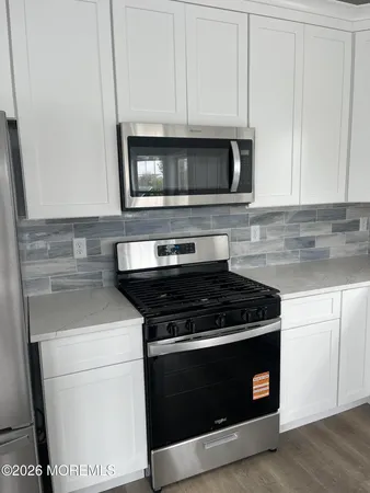 a stove top oven sitting inside of a kitchen