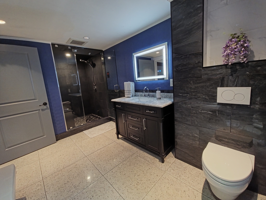 9 Venner Road Arlington, MA 02476 - Photo 14 of 40 a bathroom with a toilet sink and mirror