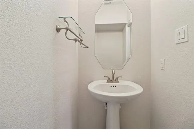 a bathroom with a sink and mirror
