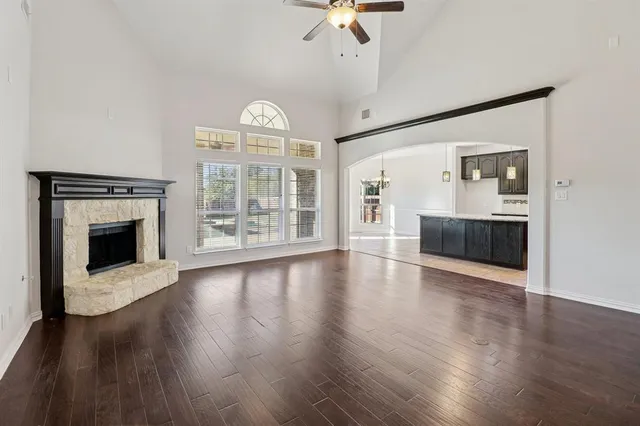 a view of empty room with wooden floor and fireplace