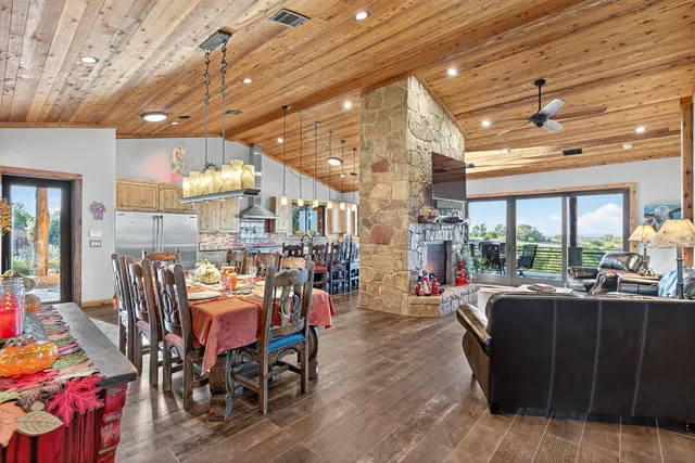 a view of a dining room with furniture and a chandelier