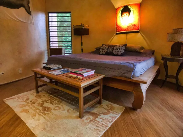 a bedroom with a bed and a night stand