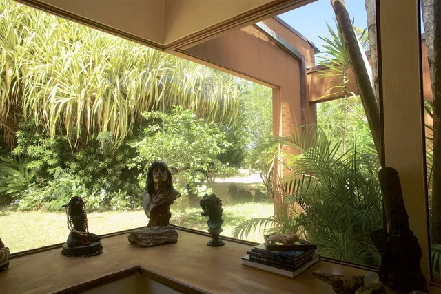 a vase of flowers sitting next to a window