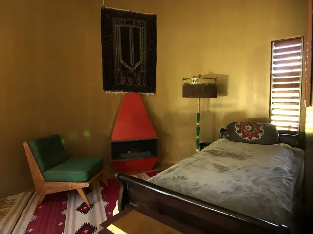 a bedroom with a bed and chair