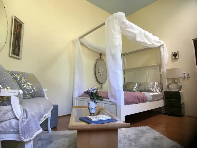 a living room with furniture and a mirror