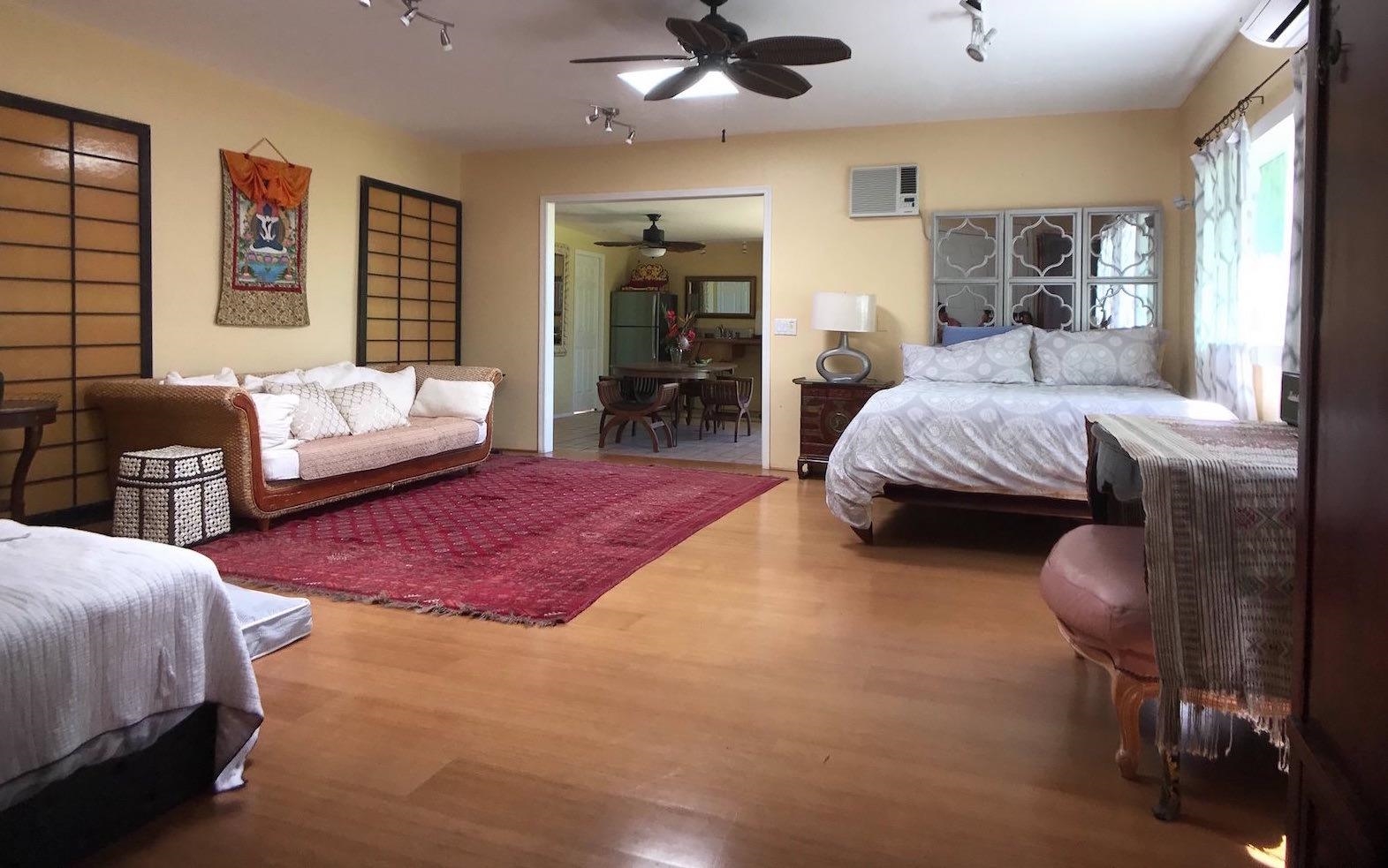 107 West Kuiaha Road Haiku, HI 96708 - Photo 19 of 49 a spacious bedroom with a bed a couch and dresser