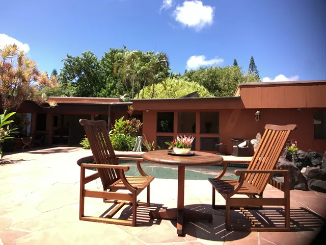 a view of patio with table and chairs and potted plants