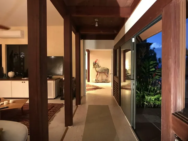 a hallway with hardwood floor and living room