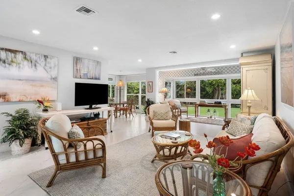 a living room with furniture and floor to ceiling window