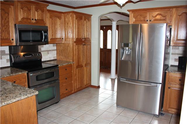 711 3rd Avenue West Springfield, TN 37172 - Photo 4 of 16 a kitchen with stainless steel appliances granite countertop a refrigerator and a stove