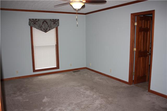 711 3rd Avenue West Springfield, TN 37172 - Photo 7 of 16 an empty room with a window and chandelier fan