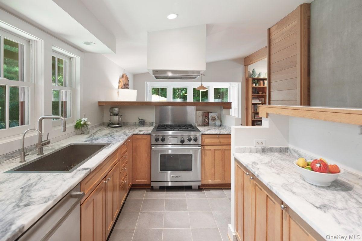 1821 Spring Valley Road Ossining, NY 10562 - Photo 22 of 48 The kitchen, open to the living and dining rooms, features a Wolf range and an abundance of quartz counterspace for the aspiring chef.